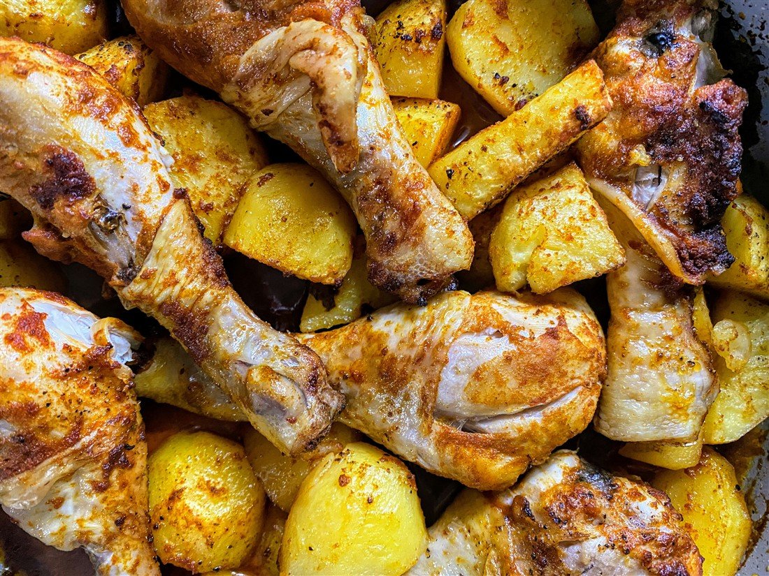 Illustrative tray of roasted chicken and potatoes from the current website